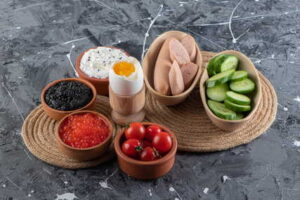 High-protein foods including eggs, salmon, cucumber, and seeds.