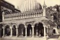 Blurred view of Nizamuddin Auliya Dargah with steps and stone architecture.