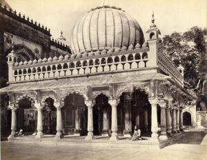 Blurred view of Nizamuddin Auliya Dargah with steps and stone architecture.