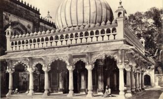 Blurred view of Nizamuddin Auliya Dargah with steps and stone architecture.