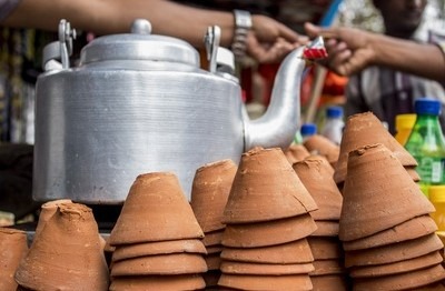 Stacked clay cups with a kettle at a roadside tea stall
