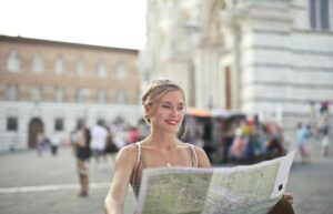 A woman reading map while traveling in a city