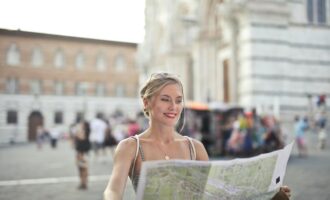 A woman reading map while traveling in a city