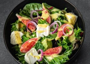 Fresh salad with figs, cheese, and leafy greens