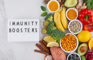 Healthy immunity boosting foods with citrus fruits, ginger, turmeric, honey, avocado and vegetables on white background